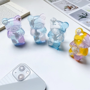 Detailed close-up of cloud bear phone grips with resin gradient and real dried flowers