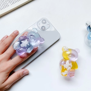 Detail of purple bear phone grip holder with semi-transparent resin on a smartphone