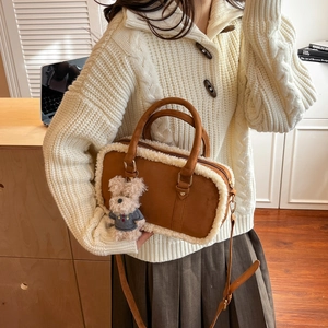 Brown retro square shoulder bag with white faux fur trim and bear charm on white sweater