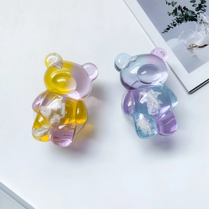 Detailed view of clear cloud bear phone grips with colorful gradient resin textures