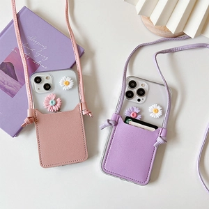 Detailed view of crossbody iPhone cases with card holders and 3D daisy flower charms