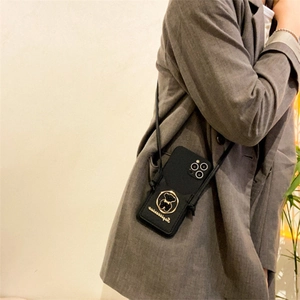 Crossbody black leather iPhone case with gold bear emblem and long adjustable shoulder strap