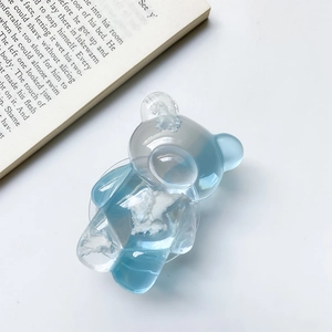 Macro view of blue gradient bear phone grip with cloud texture and transparent base
