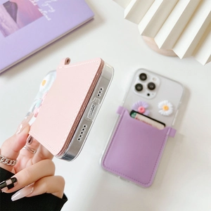 Macro detail of iPhone case with pastel leather card holder and 3D daisy flowers