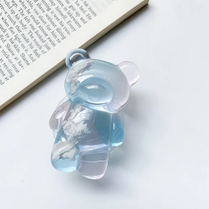Detail of cute bear cloud phone grip in gradient blue and pink translucent resin material