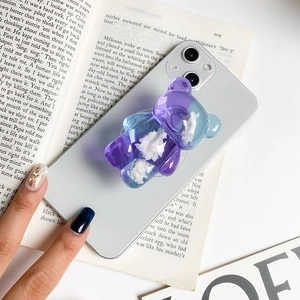 3D bear phone grip with blue-purple gradient and cloud elements on a smartphone