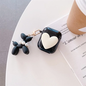 Detail of black AirPods case with 3D heart and pearl-studded balloon dog keychain