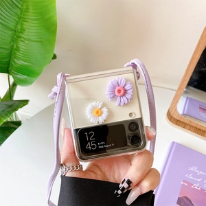 Detailed view of Z Flip 6 clear case featuring 3D daisies and purple crossbody strap