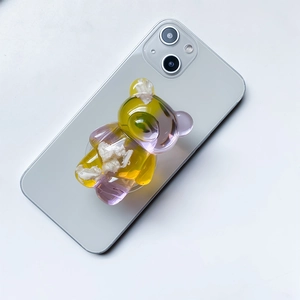 Minimalist resin bear phone grip with yellow and purple gradient and white floral accents