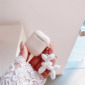 Detail of cream wireless earphone case with a white pearl-bead balloon dog charm