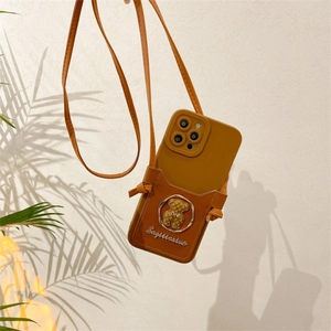 Detail of caramel leather iPhone case with bear logo card holder and crossbody strap