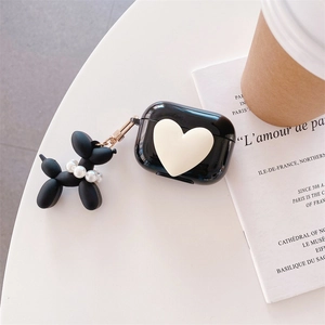 Glossy black AirPods Pro case featuring a 3D cream heart and balloon dog pearl charm