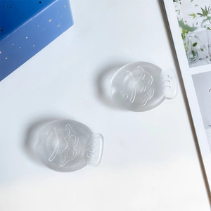 Detail of matte fish phone sockets with fine glitter texture on white surface