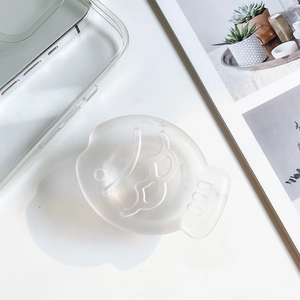 Detail view of fish-shaped matte silicone expanding phone socket on minimalist background