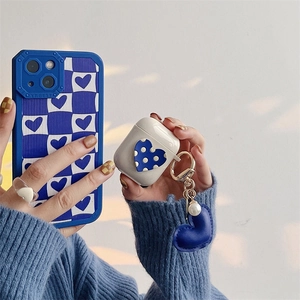 Detail view of Klein blue checkered phone case and AirPods cover with heart pendant