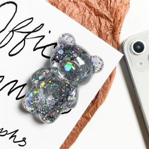 Detailed macro of dark gray transparent bear phone grip with rainbow laser sequins