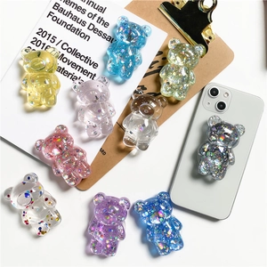 Detailed view of colorful glitter resin bear phone sockets with glossy finish