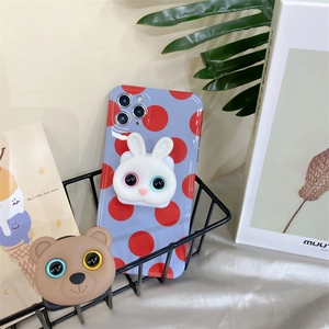Close-up of cute rabbit and bear phone stand on polka dot case in a mesh basket