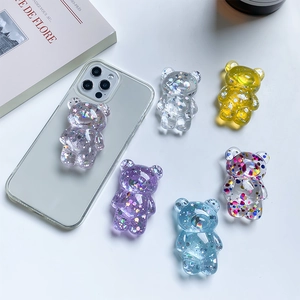 Detail view of 3D transparent bear phone socket grips with colorful sequins and glitters