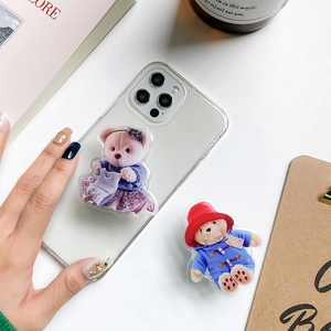 Close-up of 3D bear phone grip sockets on clear protective case in aesthetic setup