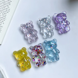 Detail showing 6 colors of cute resin bear phone grips with sparkly glitter and sequins