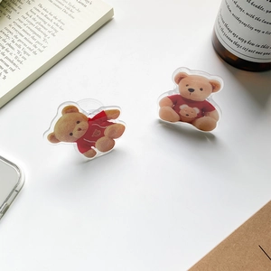 Detail of cute acrylic brown bear phone grip stands in sitting and lying poses