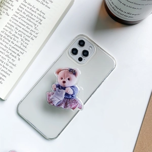 Detail of cute acrylic bear phone socket on a clear case with a pink floral dress