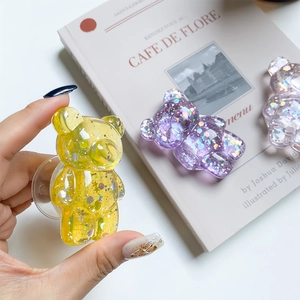 Detail showing bear phone socket with colorful glitter and stars in transparent resin