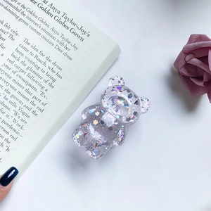 Macro shot of bear-shaped phone grip with holographic glitter and star sequins