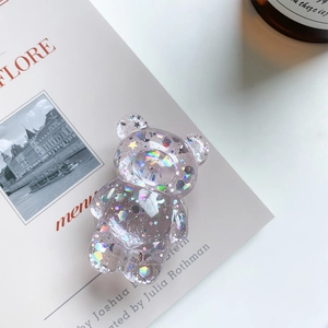 Detail view of transparent bear phone grip with sparkling colorful sequins and stars