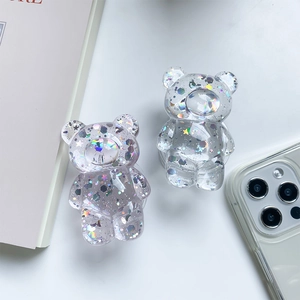 Macro detail of transparent bear phone grips with holographic colorful glitter and sequins