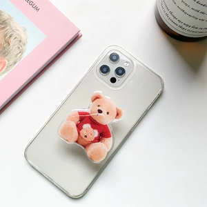 Cute teddy bear phone grip stand on transparent iPhone case with red sweater detail