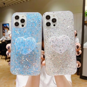 Detail of glitter gradient phone cases with matching heart-shaped folding pop sockets