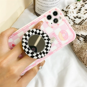 Detail of checkered phone case featuring an integrated makeup mirror and princess graphics