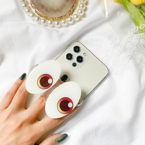 Detail of big-eye phone socket stand on white smartphone with aesthetic props
