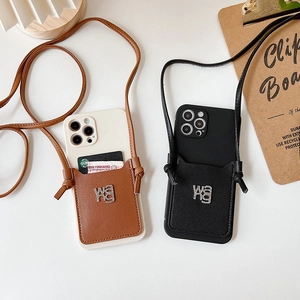 Detail of leather crossbody phone cases with card slots and rhinestone logo on table
