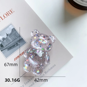 Detail of transparent bear phone grip with holographic sequins and precise dimensions