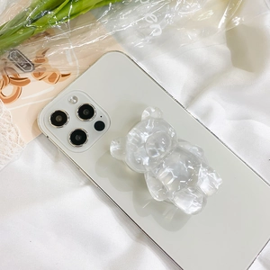 Detailed view of the cute pink bear acrylic Griptok attached to a white smartphone
