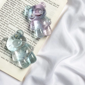 Macro detail of gradient transparent bear phone grip on open book pages