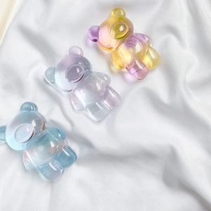 Set of 3 gradient colorful bear phone sockets on a soft white satin fabric background
