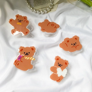 Detailed view of cute brown cartoon bear acrylic pop-up sockets for mobile phones