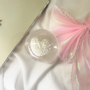 Detail of transparent phone Griptok with a 3D textured white heart and soft aesthetic