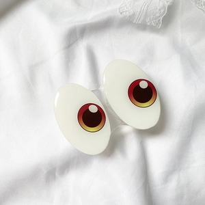 Detail shot of creative cartoon eye phone grips on white fabric with lace decor