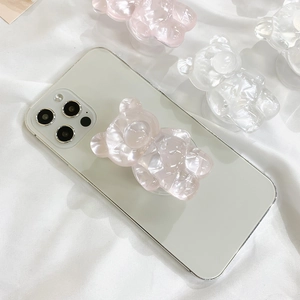 Detailed macro view of 3D pink cartoon bear pop socket on a smartphone back