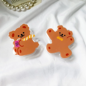 Detailed view of cute brown acrylic bear phone sockets on white textured background
