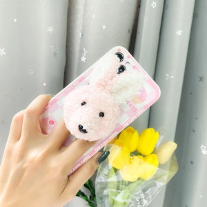 Detail of cute 3D plush bunny phone grip on a pink checkerboard phone case