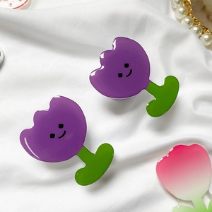 Macro detail of tulip-shaped acrylic phone grips with smile faces and colorful gradients