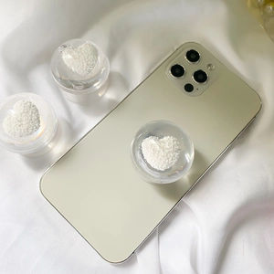 3D transparent crystal ball phone grip with plush white heart interior on silk fabric