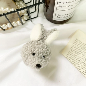 Close-up of cute plush bunny phone grip with soft grey lamb wool and bead eyes