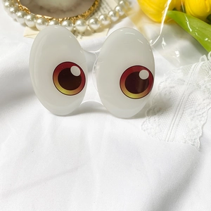 Detail showing cartoon big eye phone grip sockets on a soft white fabric background